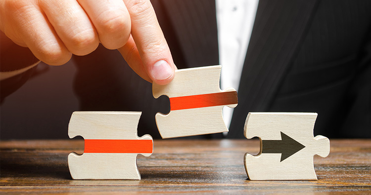 image of a hand putting puzzle pieces together