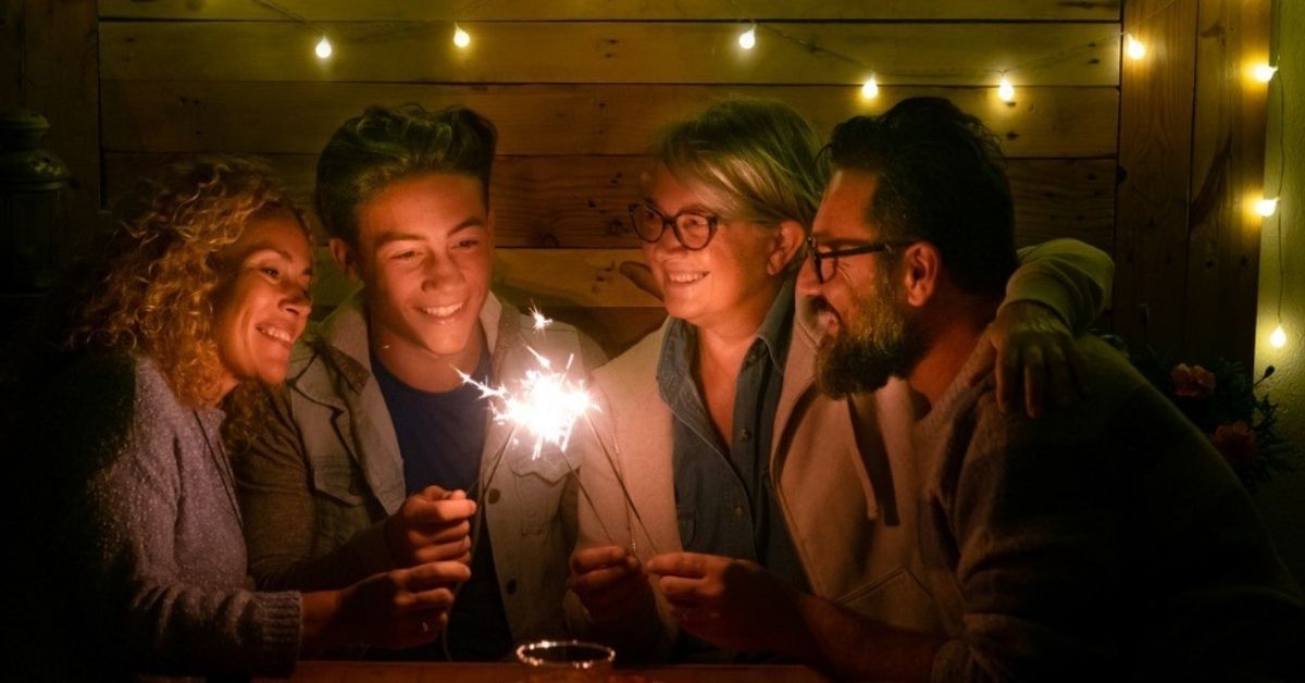 A family lights sparklers to celebrate the New Year