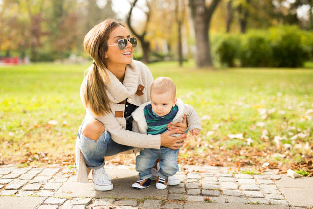 A young mother smiling with her child.