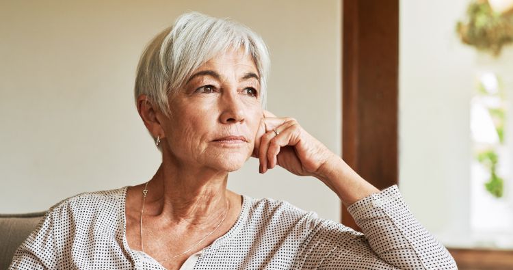 Older woman looking out the window