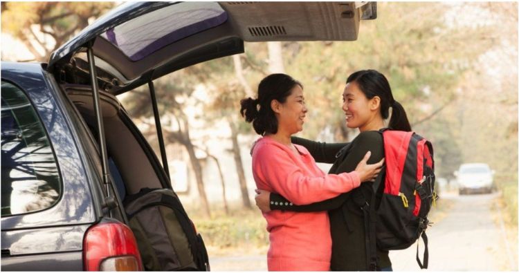 A mother hugs her daughter before she leaves for college.