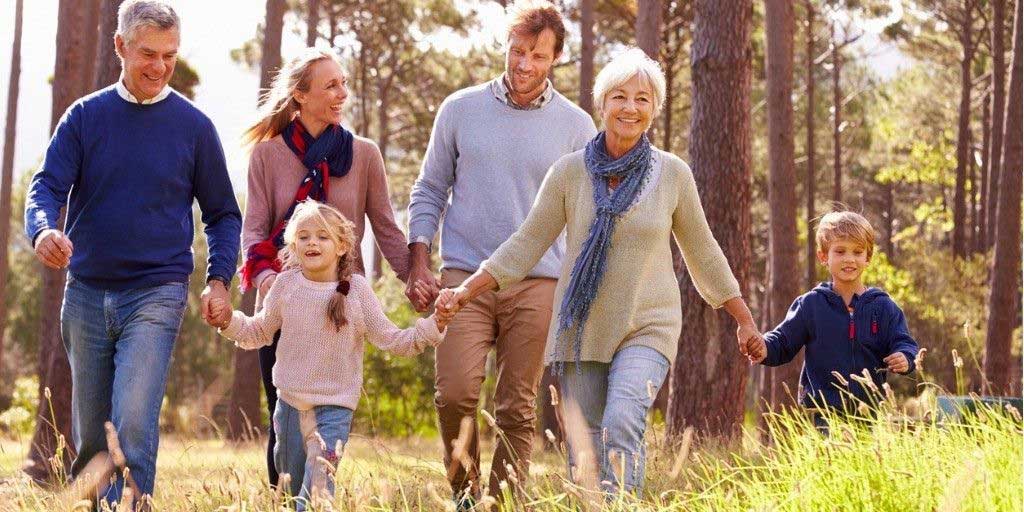 A large family take a hike on a sunny day