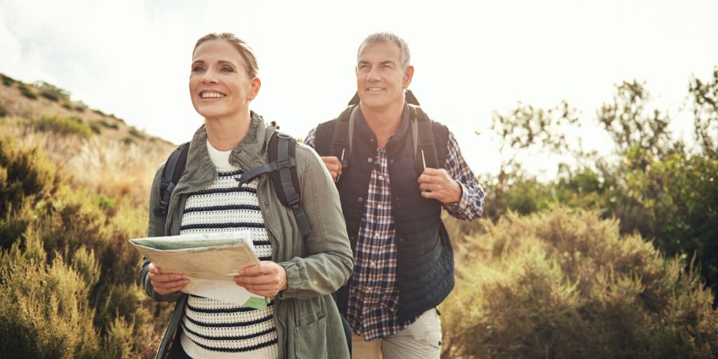 A couple smiles while hiking.