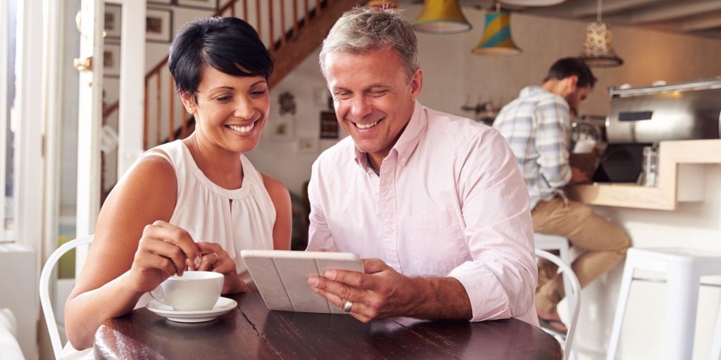 late 50s couple discuss fixed annuities over coffee