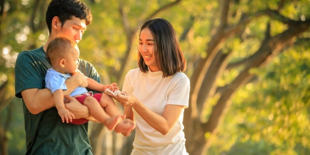 Young Asian family enjoys a day in the park