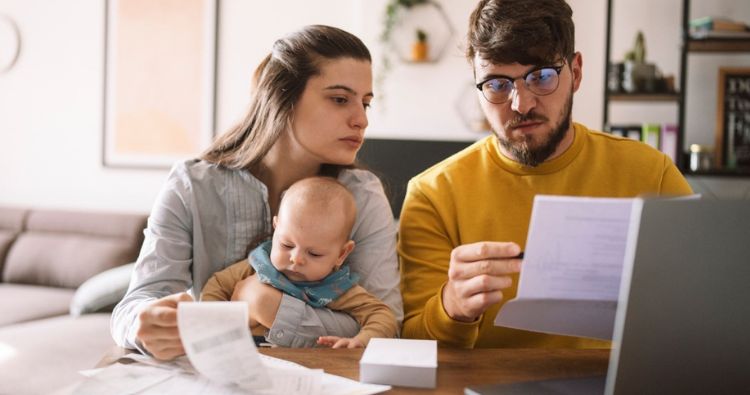 A young family reviews financial documents together.