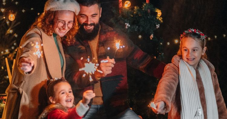 A family celebrates the New Year together with sparklers.