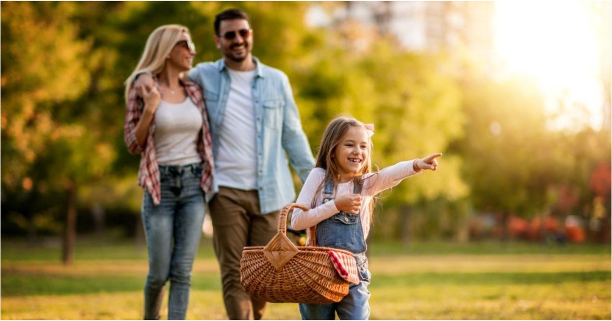 A young family enjoy a sunny spring day in the park.