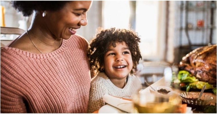 A mother and son enjoy Thanksgiving dinner together.