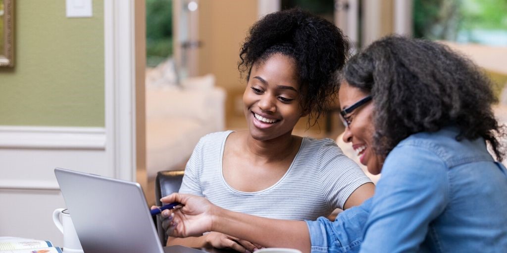 mom and daughter review college expenses