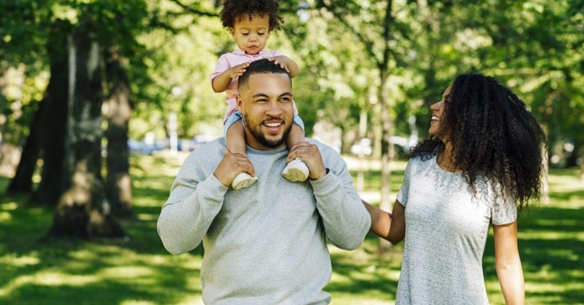 A young family walk in the park together