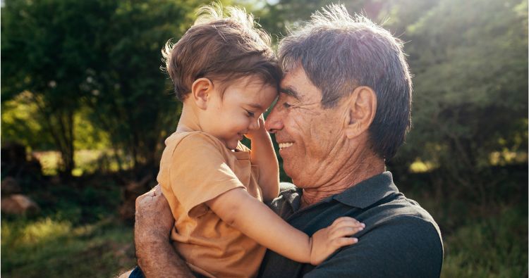 A grandfather holding his grandson