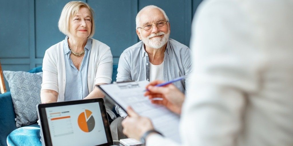 An older couple meet with a financial professional to discuss their retirement money