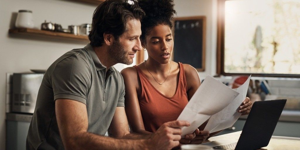 A young couple looks over their financial documents together