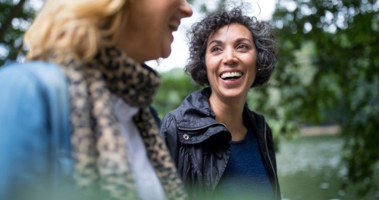 Two women walk together in the park