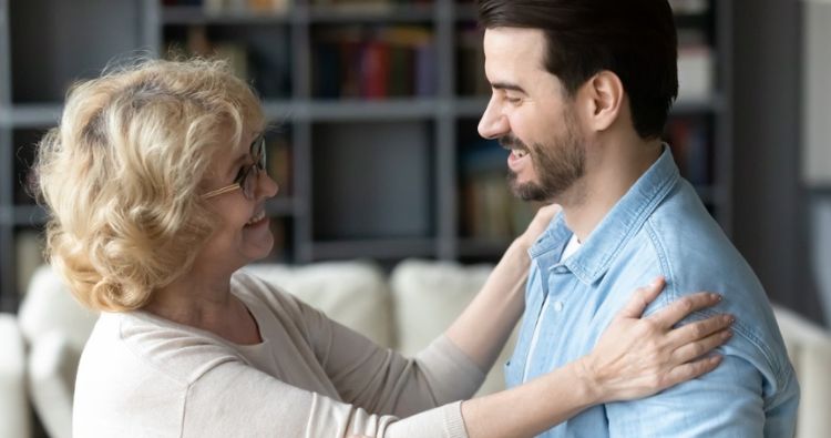 A woman tightly hugs her mom.