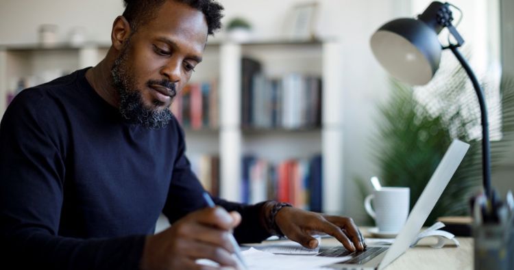 A man reviews his personal financial files while creating an organization system.