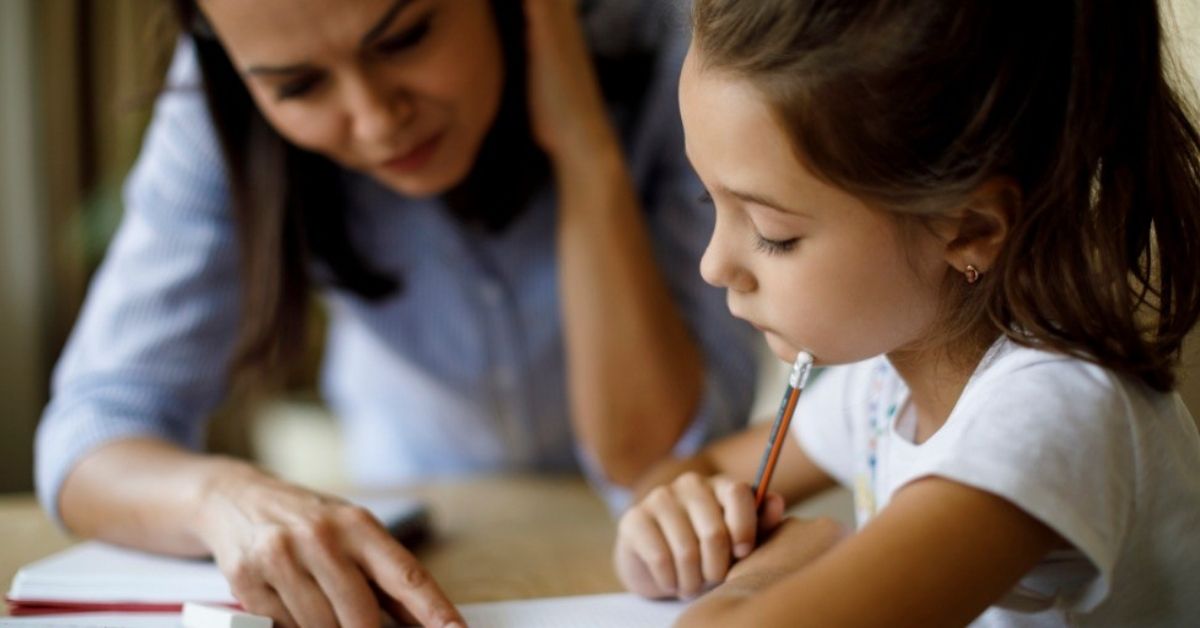 A young mother teaches her daughter at home