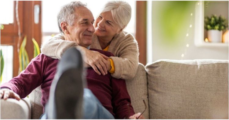 An older couple share a loving moment together.