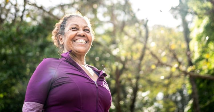 A retirement-aged woman take a run in the park