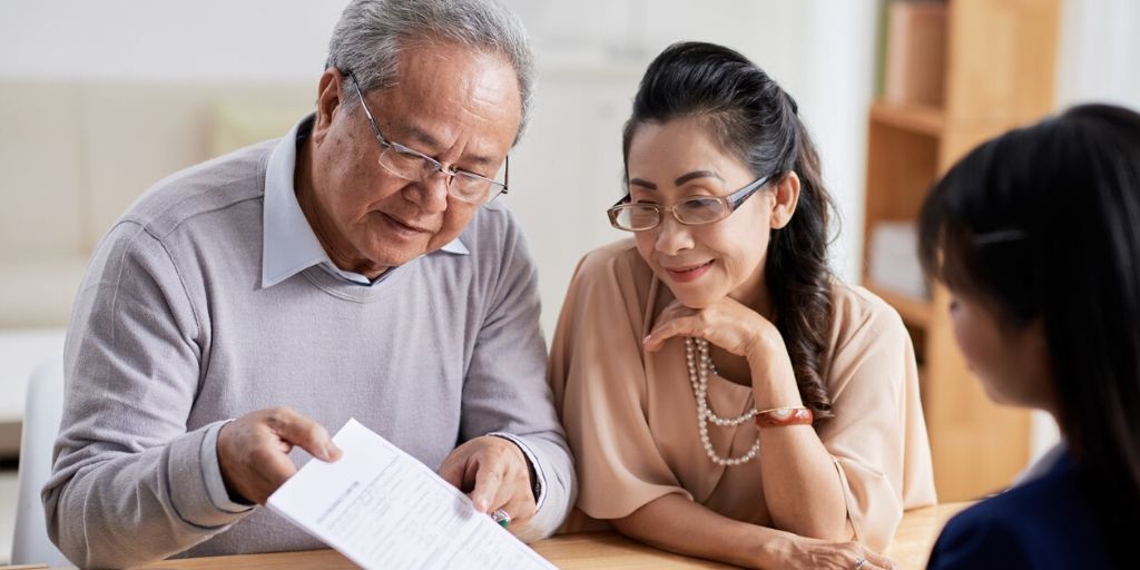 early 60s asian couple reviewing their retirement plans