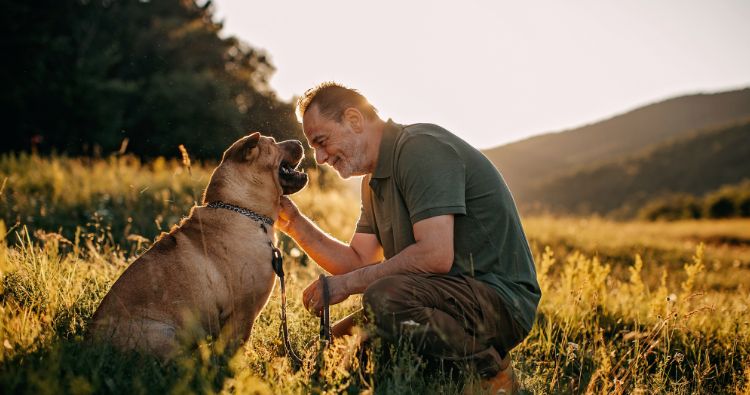 A man spending time with his dog outdoors