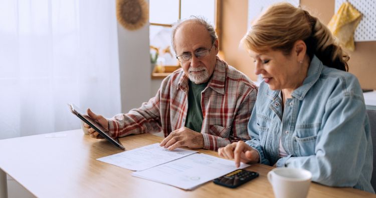 A retirement aged couple go over budget and expenses together.