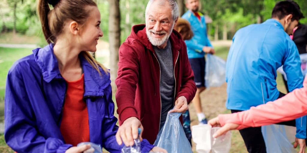 retired senior male volunteering at recycle center