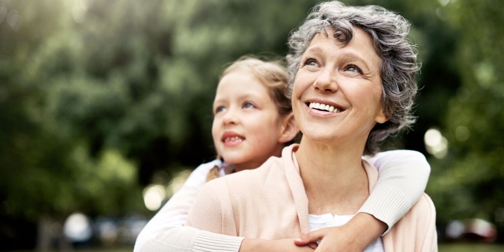 grandmother giving granddaughter piggyback ride
