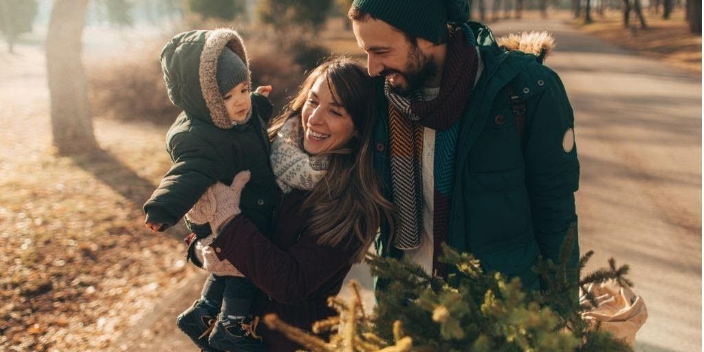 A young family walks in the park on a sunny fall day