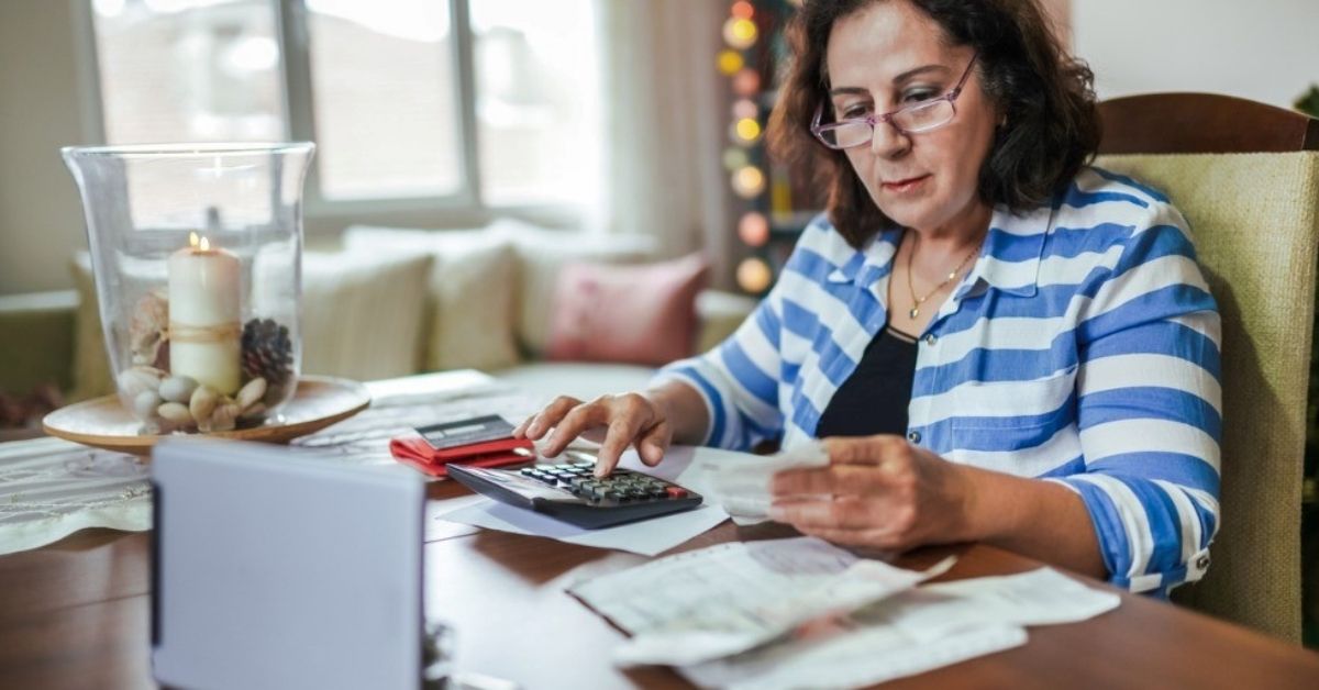 A retiree woman works through her taxes.