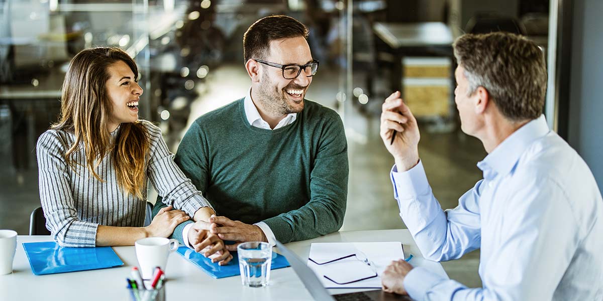 Three people meeting at a table