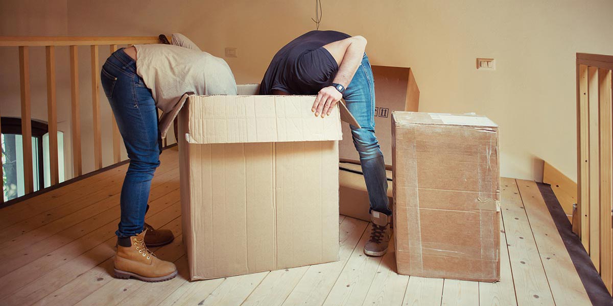 Two people with their heads looking inside a box