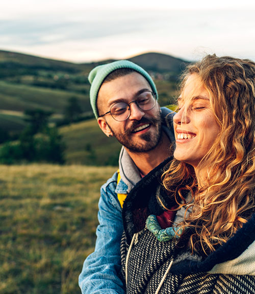 Early 30s couple taking a walk on a hillside