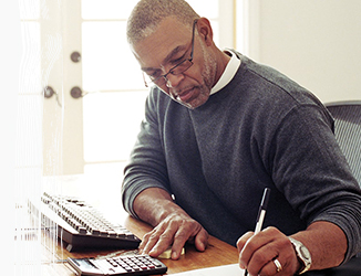 Man sitting at desk writing