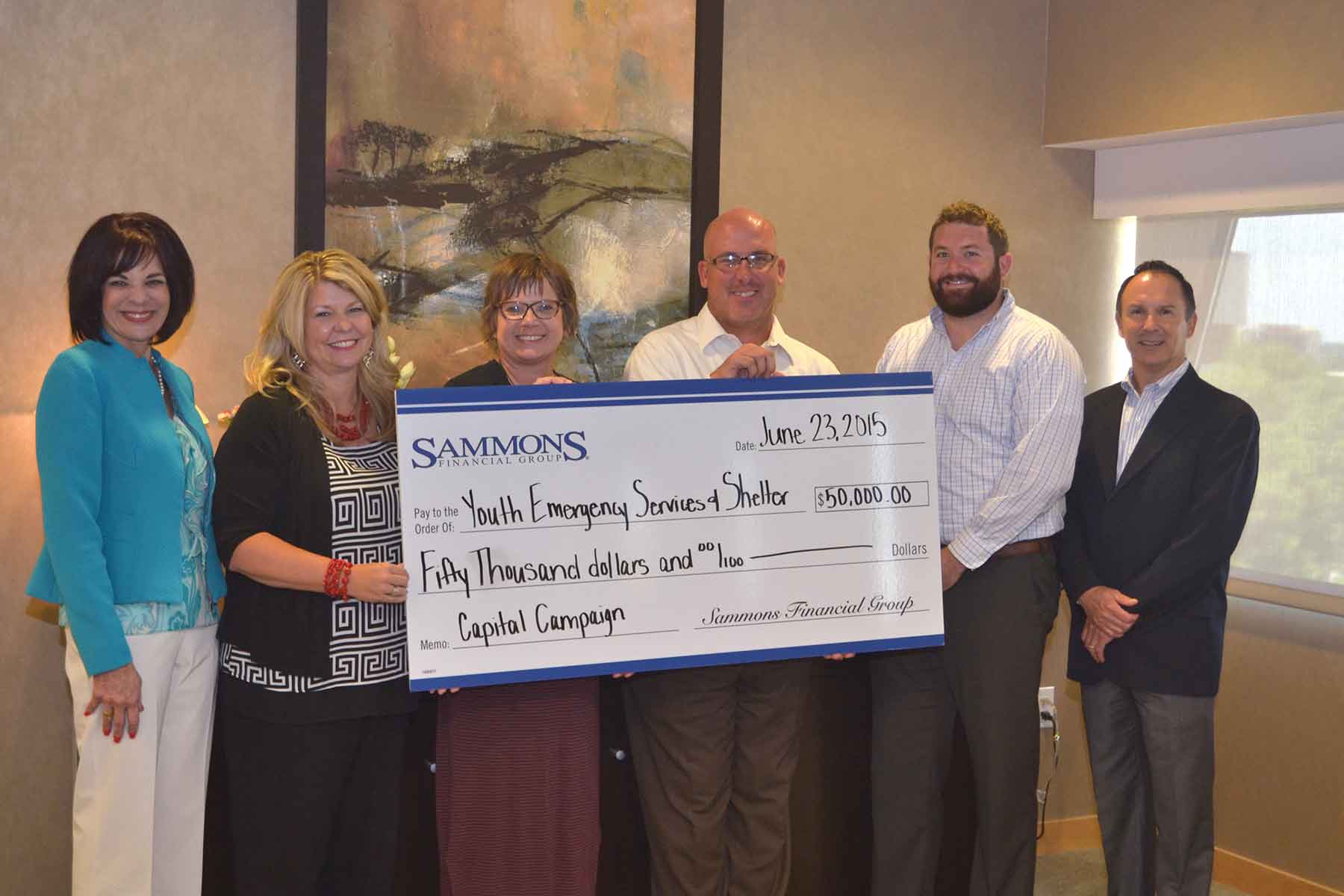 Sammons Financial Group presents a $50,000 check to Youth Emergency Services & Shelter's (YESS) Shelter Expansion Project.