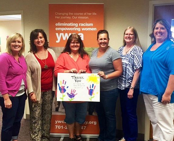 Sammons employees holding painted picture of hands