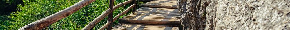 An image of a wooden bridge against the side of a rocky mountain.